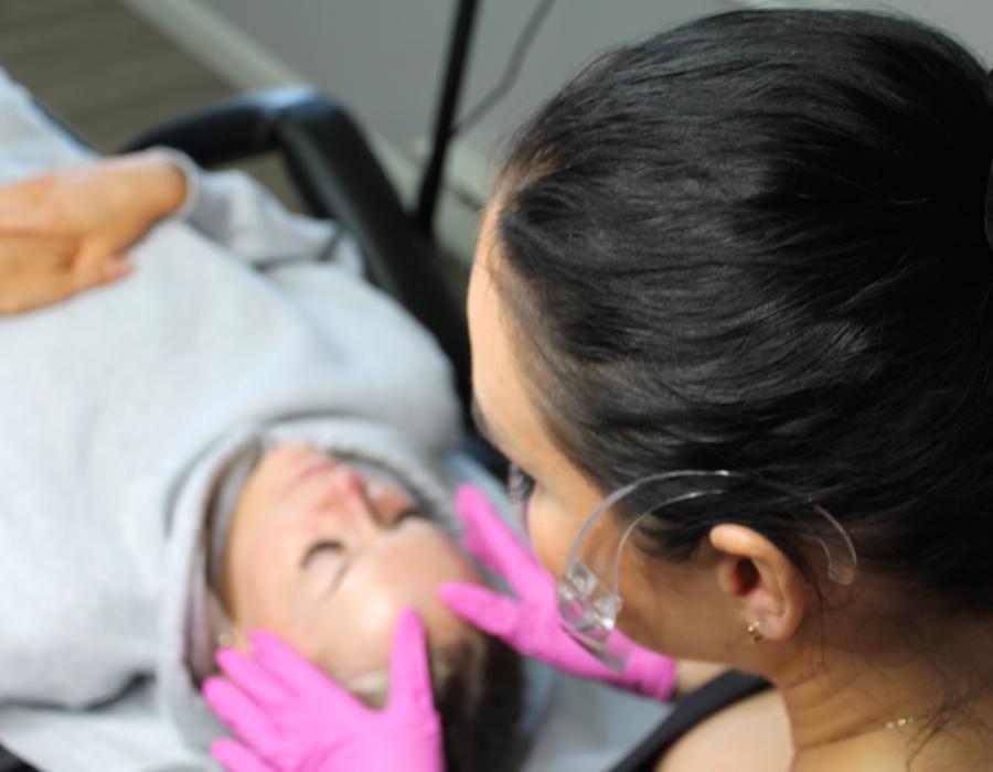 Esthetician providing microblading service to client